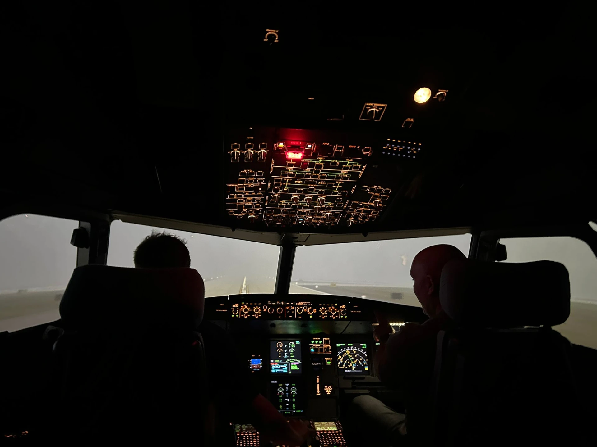 The simulator flight deck in low light during a foggy takeoff