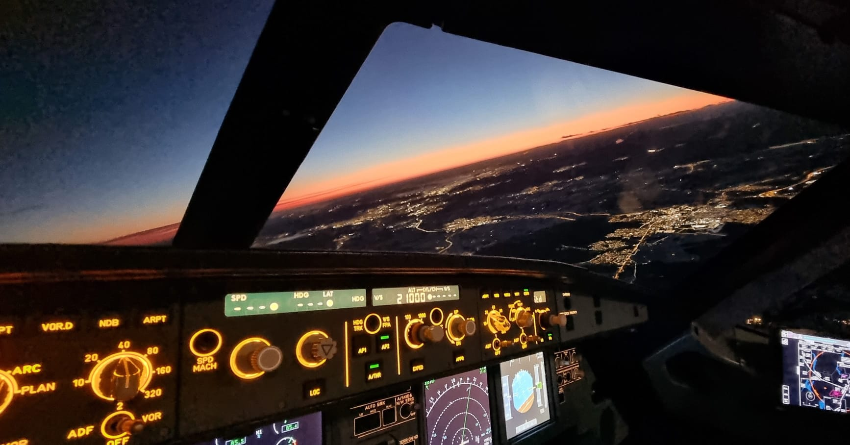 City lights below during a night approach